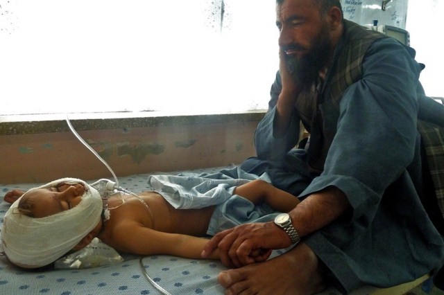 یک پدر افغان در کنار فرزند خردسالش