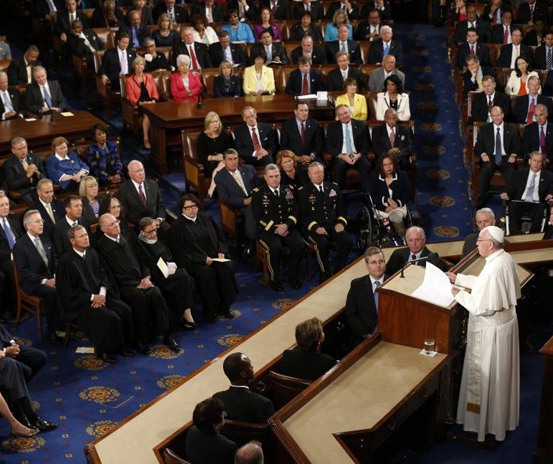 برداشتن لیوان آب پاپ برای تبرک توسط عضو کنگره آمریکا