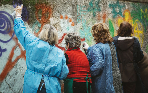 زنان هنرمند در حال خلق یک نقاشی دیواری بزرگ در شهر لیسبون پرتغال
