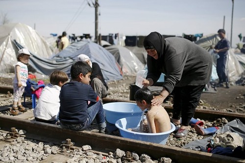 حمام کردن کودکان در اردوگاه پناهجویان در مرز یونان و مقدونیه
