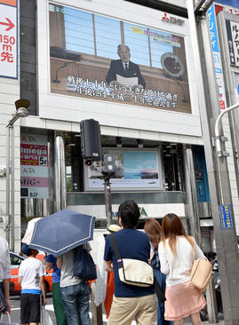 شهروندان توکیو در حال گوش فرا دادن به صحبت های امپراتور ژاپن که به طور زنده از تلویزیون در حال پخش است. امپراتور آکیهیتو 82 ساله در این سخنرانی گفت دیگر شرایط جسمانی او اجازه نمی دهد در نقش امپراتور ایفای وظیفه کند